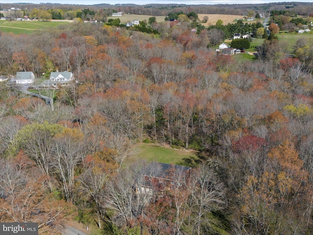 birds eye view of property with a view of trees