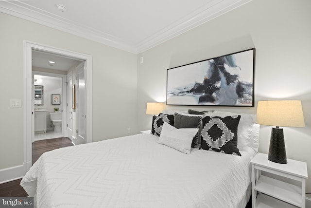 bedroom with dark wood-style floors, baseboards, ensuite bath, and crown molding