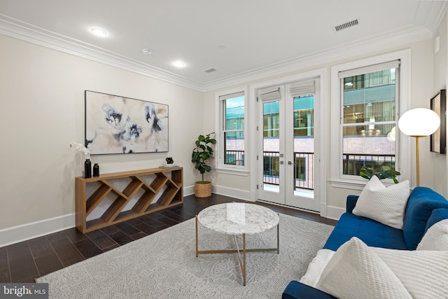 living room with ornamental molding, visible vents, dark wood finished floors, and baseboards