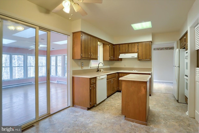 kitchen with a kitchen island, sink, ceiling fan, baseboard heating, and white appliances