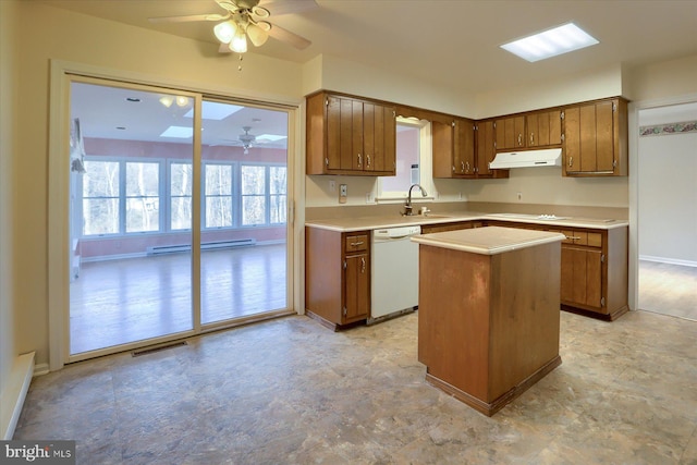 kitchen featuring sink, ceiling fan, a baseboard heating unit, a center island, and white dishwasher