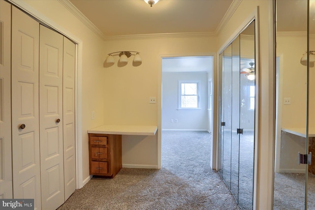 hallway featuring crown molding and light colored carpet