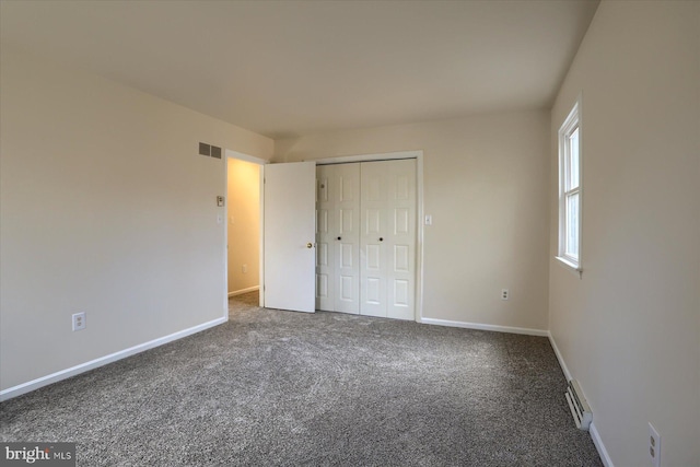 unfurnished bedroom with carpet flooring and a closet