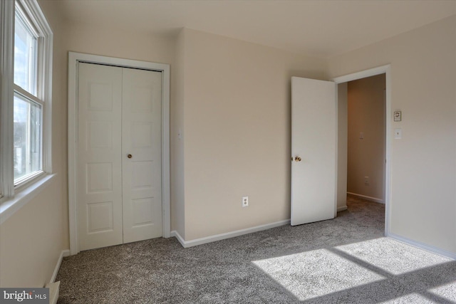 unfurnished bedroom with carpet flooring and a closet