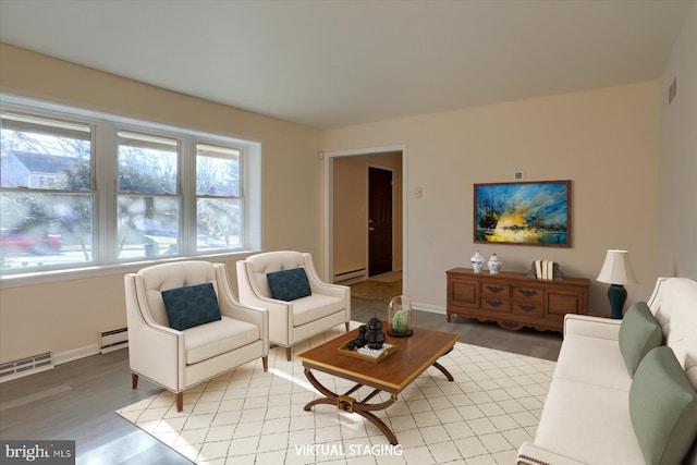 living room with a baseboard heating unit and light hardwood / wood-style floors