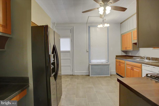 kitchen featuring ceiling fan, sink, white dishwasher, and black fridge with ice dispenser