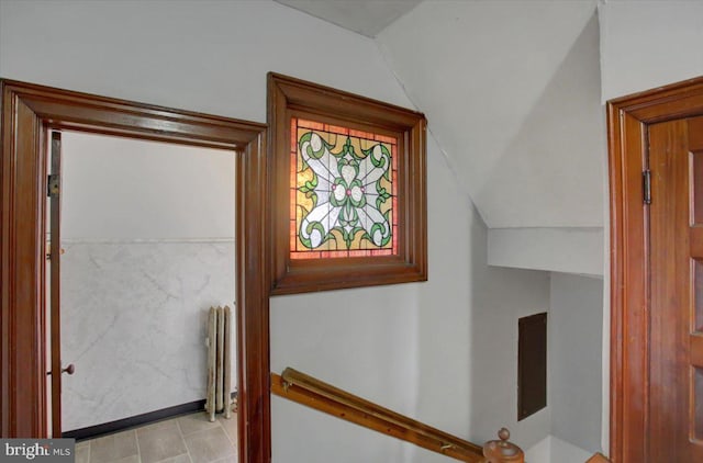 corridor featuring lofted ceiling