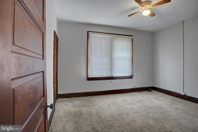 carpeted empty room featuring ceiling fan