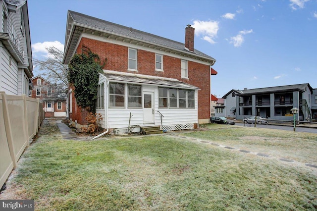 back of house featuring a lawn