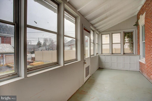 unfurnished sunroom with lofted ceiling