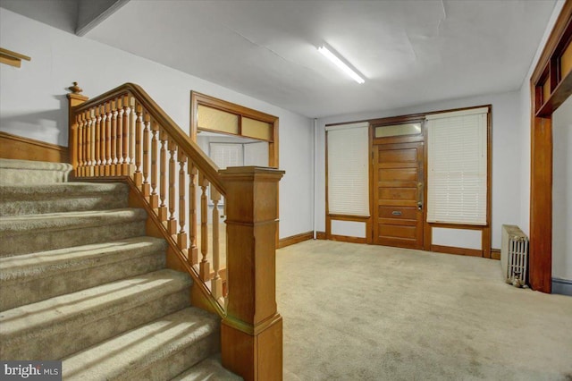 staircase featuring carpet and radiator heating unit