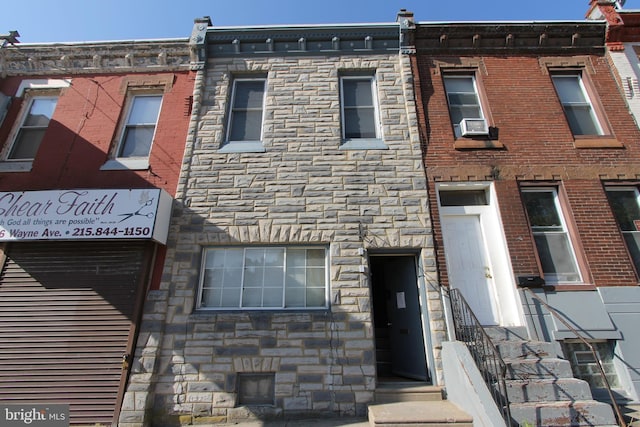 townhome / multi-family property with stone siding and brick siding