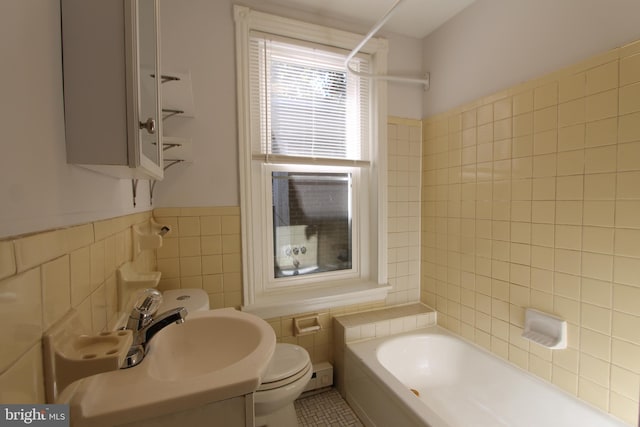 bathroom featuring tile walls, sink, and toilet