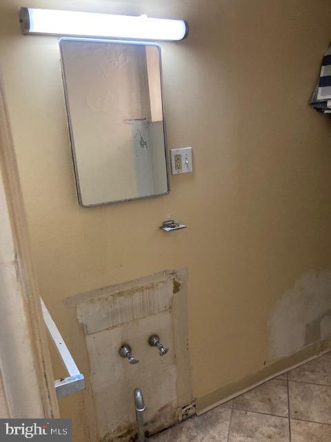 bathroom with tile patterned floors and baseboards