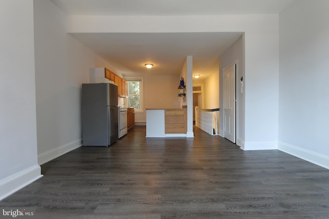 unfurnished living room featuring baseboards and dark wood finished floors