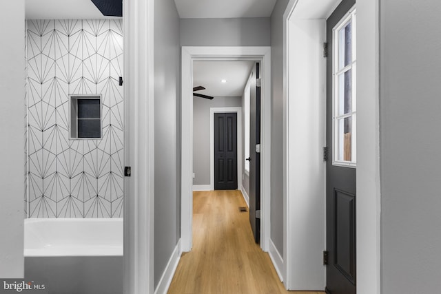 corridor with light hardwood / wood-style flooring