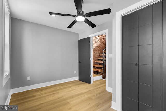 empty room with ceiling fan and light wood-type flooring