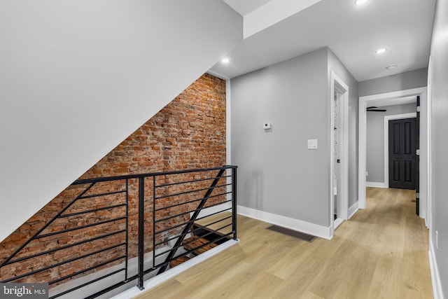 corridor with light hardwood / wood-style floors