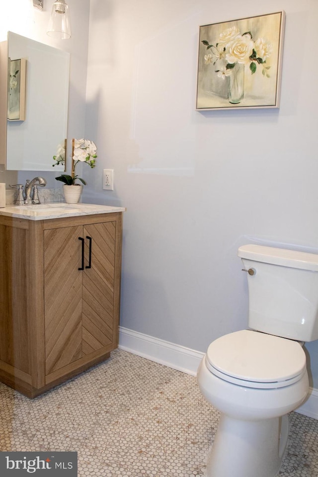 bathroom with vanity, tile patterned flooring, and toilet