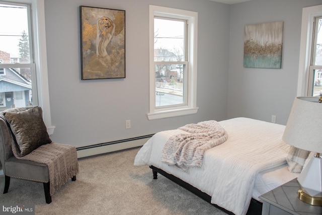 carpeted bedroom featuring baseboard heating