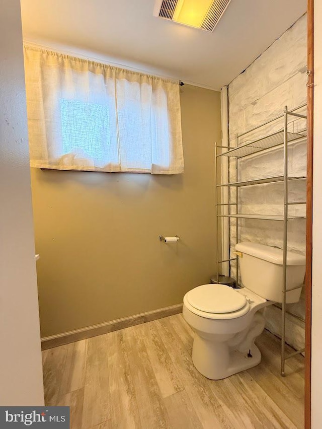 bathroom featuring hardwood / wood-style floors and toilet