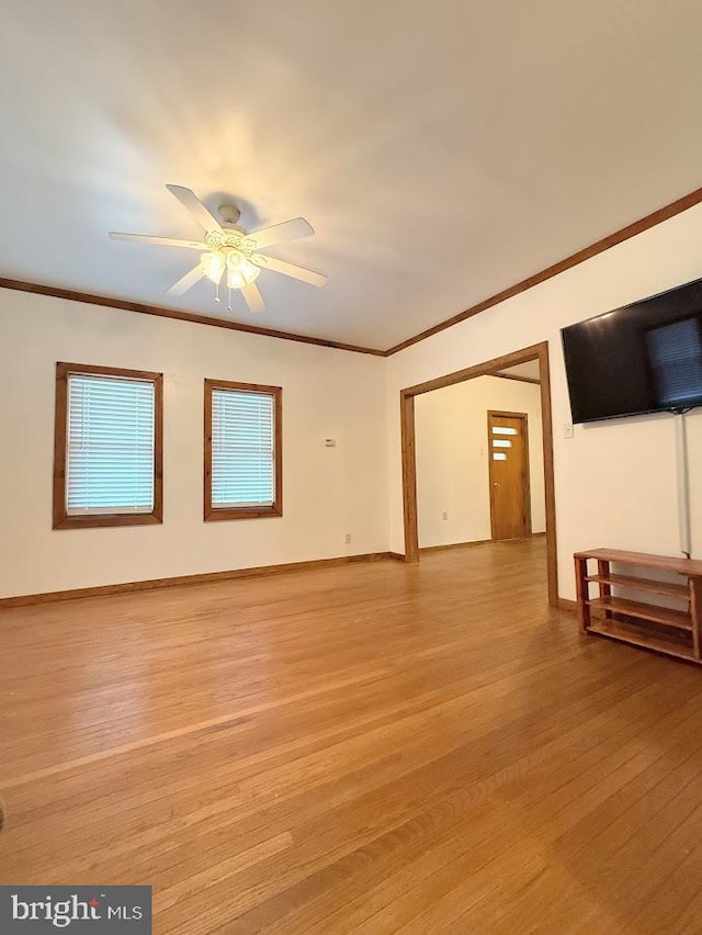 unfurnished living room featuring light hardwood / wood-style flooring and ornamental molding