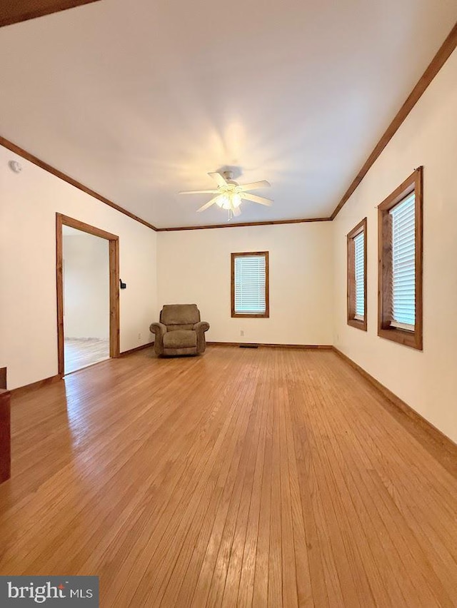 spare room with crown molding, ceiling fan, and light hardwood / wood-style flooring