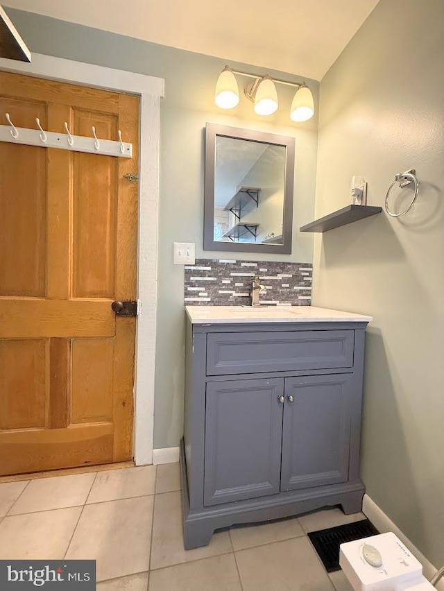 bathroom featuring tasteful backsplash, tile patterned floors, and vanity