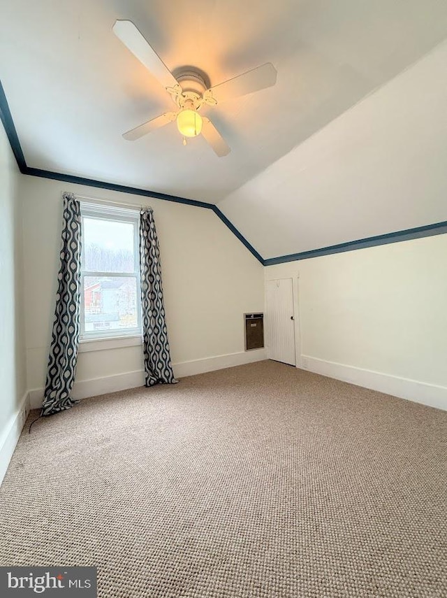 additional living space with ceiling fan, vaulted ceiling, and carpet