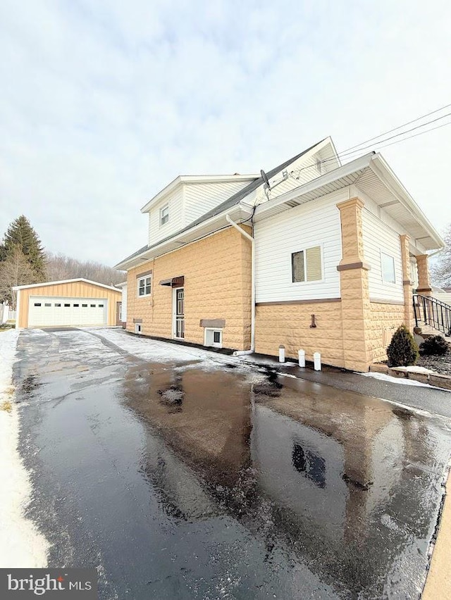 view of side of property with an outbuilding and a garage