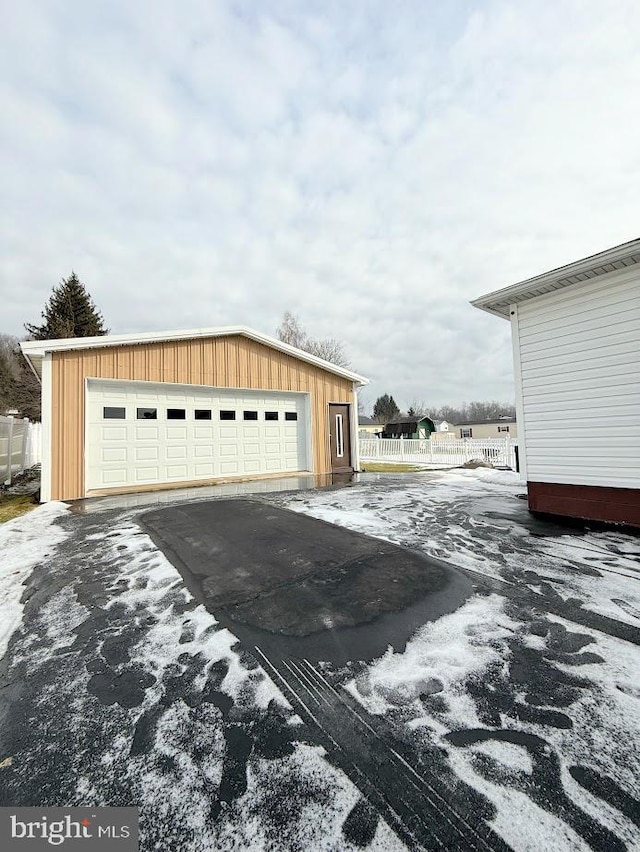 view of property exterior featuring a garage and an outbuilding