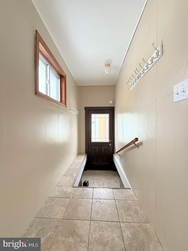 doorway with light tile patterned floors