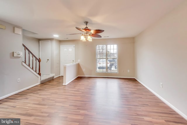 unfurnished living room with ceiling fan and light wood-type flooring