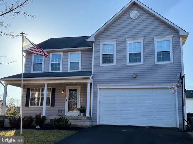 view of front of property featuring a garage and a porch