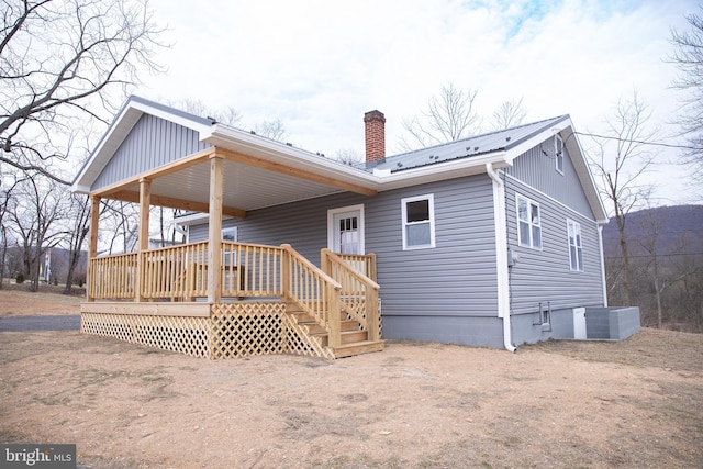 back of property with a deck and central air condition unit