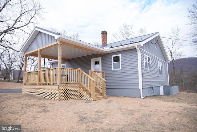 back of property with cooling unit and a deck