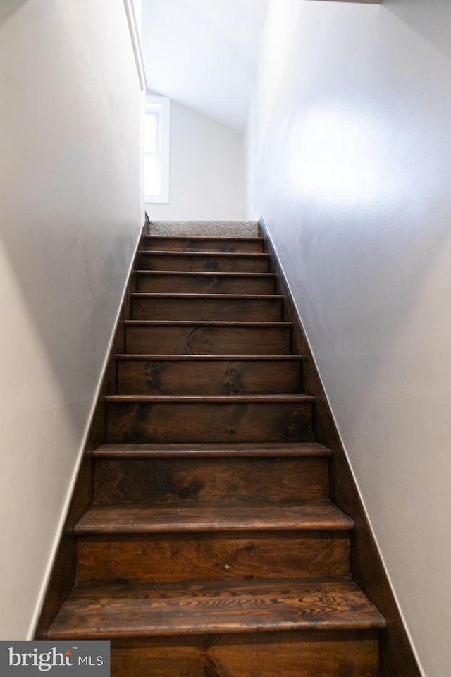 staircase with lofted ceiling