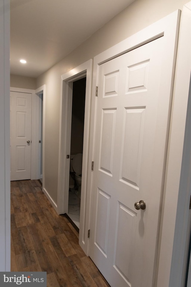 hallway with dark hardwood / wood-style flooring