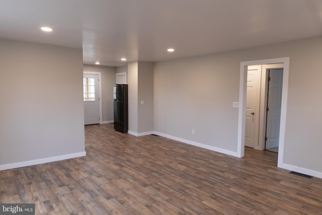 empty room featuring dark wood-type flooring