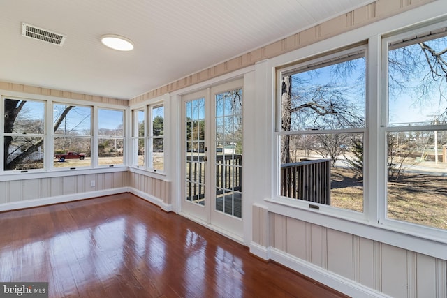 unfurnished sunroom featuring visible vents