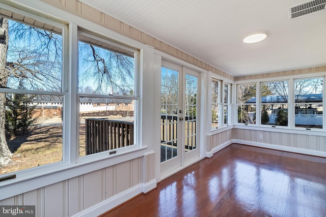 unfurnished sunroom featuring a healthy amount of sunlight and visible vents