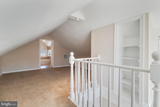 bonus room featuring visible vents, baseboards, lofted ceiling, and carpet floors