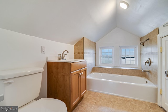 bathroom with tile patterned floors, toilet, vanity, and vaulted ceiling