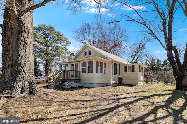 view of front of house with central air condition unit and a sunroom