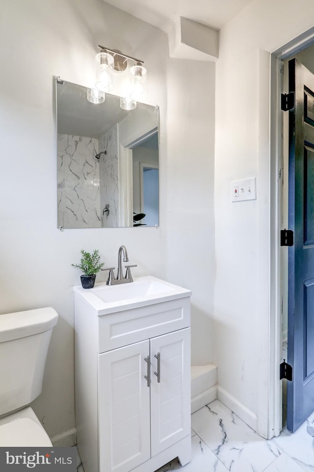 bathroom featuring vanity, a shower, and toilet