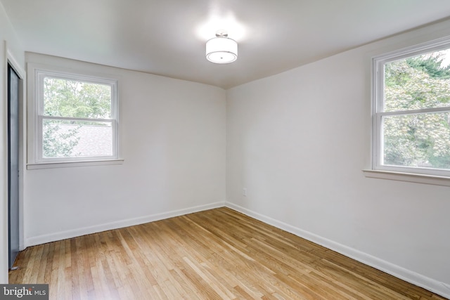 unfurnished room with light wood-type flooring