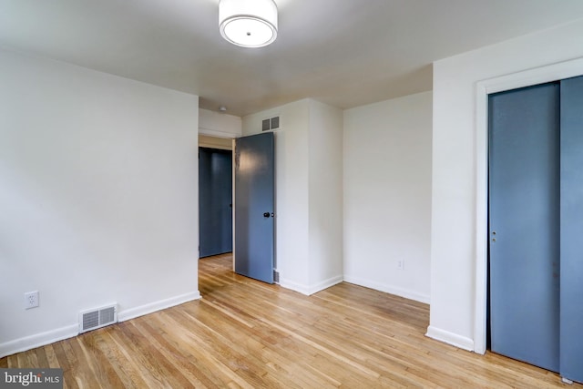 spare room with hardwood / wood-style floors