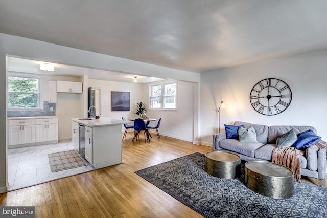 living room with sink and light hardwood / wood-style flooring