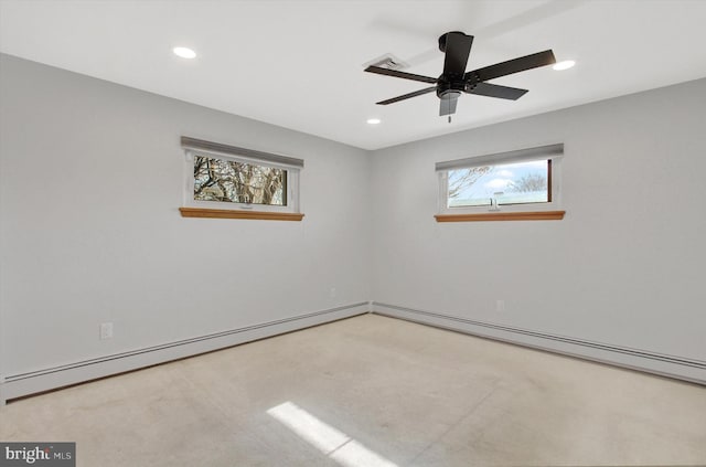 spare room with a baseboard heating unit, a wealth of natural light, and ceiling fan