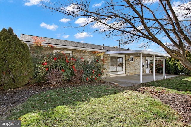 rear view of property featuring a lawn and a patio